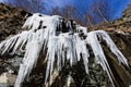 Amazing icicles hanging from a rock formation in the mountains during cold winter