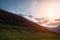 Mountain slopes during sunset. Natural summer landscape in mysterious backlight