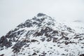 Mountain with snow cap. Mountain top in the snow on the background of the sky