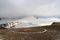 Mountain snow panorama, summit Johannisberg (High Tauern) in clouds and helicopter landing site in Glockner Group