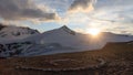 Mountain snow panorama, summit Johannisberg High Tauern and helicopter landing site during sunset in Glockner Group, Austria