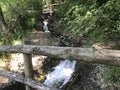 mountain springs of mineral water and cascading waterfalls down the slopes of volcanic rocks, Italian Alps