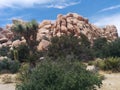 Mountain of stacked boulders, greenery, and sky