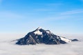 Mountain stick out of foggy cloud layer. Gruenten, Bavaria, Germany. Foresight and vision for business concept and ideas