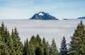 Mountain stick out of foggy cloud layer. Sea of clouds. Gruenten, Allgau, Germany.