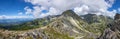 Mountain stone range peak against blue cloudy sky