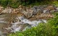 Mountain stream cascading over rocks and boulders Royalty Free Stock Photo