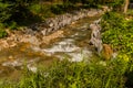 Mountain stream cascading over rocks and boulders Royalty Free Stock Photo