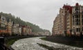 Mountain stream between houses in the rain in Sochi