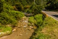 Mountain stream beside two lane paved road Royalty Free Stock Photo
