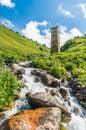 Mountain stream and watch tower in the village Adishi, Georgia