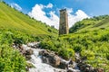 Mountain stream and watch tower in the village Adishi, Georgia Royalty Free Stock Photo