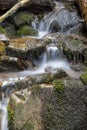 Mountain stream water flow with green moss on wet rocks. River cascade with huge stones. Royalty Free Stock Photo