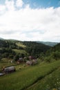 Mountain summer landscape, houses on mountain green hills and sky Royalty Free Stock Photo