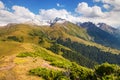 Mountain summer landscape. Snowy mountains and green grass. Peak Karakol Kyrgyzstan Royalty Free Stock Photo