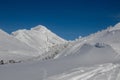 Mountain summit covered with white snow with traces on it in the winter