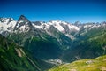 Mountain summit Dombai-Ulgen. In the background are glaciers and peaks of the Main Caucasus Range against the background of a Royalty Free Stock Photo