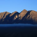 Mountain at sunrise and fog belt Royalty Free Stock Photo