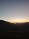 Mountain sunset with long road combination Royalty Free Stock Photo