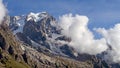 Mountain tops in summer with clouds and trees.