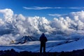 A mountain tourist looks admiring the nature before his difficult ascent to Mount Elbrus