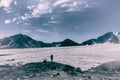 A mountain tourist looks at the glacier in front of his difficult climb to Mount Elbrus