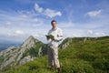 Mountain tourist with map over blue sky