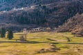 Mountain city and sunny spring meadow in the Italian Alps, Trentino, Italy Royalty Free Stock Photo