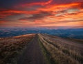 Mountain trail, hiking road on sunset sky background, travel and toursm in wild nature