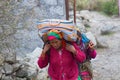 On a mountain trail in the Himalayas, cargo carrying Royalty Free Stock Photo