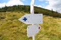 Mountain trail markings, empty sign-boards with mountain vegetation background Royalty Free Stock Photo
