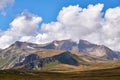 Mountain treeless landscape with clouds and blue sky