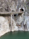 Mountain tunnel with viaduct above lake Royalty Free Stock Photo