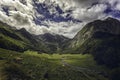 mountain valley with animals, cloudy sky and green pastures in spring from Aran, Lerida, Spain Royalty Free Stock Photo