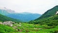 Mountain valley. Green grass, white stones and clouds Royalty Free Stock Photo