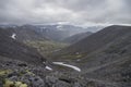 Mountain valley with mosses and rocks covered with lichens. Cloudy sky before storm. Khibiny mountains above the Arctic