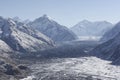 Mountain valley, the river and the body of the glacier in the February snow