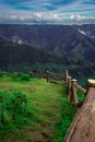 Mountain valley safety railings with dramatic sunset sky and low clouds at evening