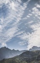 Mountain valley with slopes and rocky cliffs, stone mountain ranges with vegetation, against the background of a cloudy forest sky Royalty Free Stock Photo