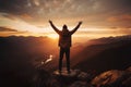 Mountain victory Man celebrates with arms raised at sunset landscape