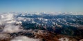 Mountain view from airplane. Mountain view from an airplane window. Scenic View Of Snowcapped Mountains Against Sky. View over the