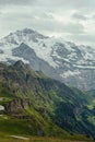 Mountain view Mannlichen. Snowy mountain ridges and deep valleys with green fields, Bernese Oberland, Switzerland Alps Royalty Free Stock Photo