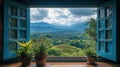 Mountain view seen through open teal window with potted plants Royalty Free Stock Photo
