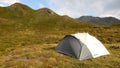 Mountain view with small camping tent