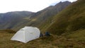 Mountain view with small camping tent