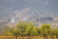 Mountain from view with small village and flow fog. Foggy summer morning in the mountains and a small village. Country road in the Royalty Free Stock Photo