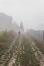 Mountain from view with small village and flow fog. Little girl in red and foggy summer morning in the mountains and a small Royalty Free Stock Photo