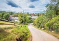 Mountain from view with small village sunny day. Sunny summer morning in the mountains and a small village. Country road in the Royalty Free Stock Photo