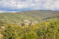 Mountain from view with small village sunny day. Sunny summer morning in the mountains and a small village. Country road in the Royalty Free Stock Photo