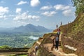 Mountain view. Unidentified people are walking on top of a mountain, around the remains of an ancient fortress